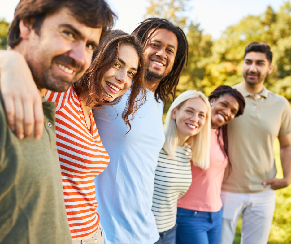 Adults standing in a line outside