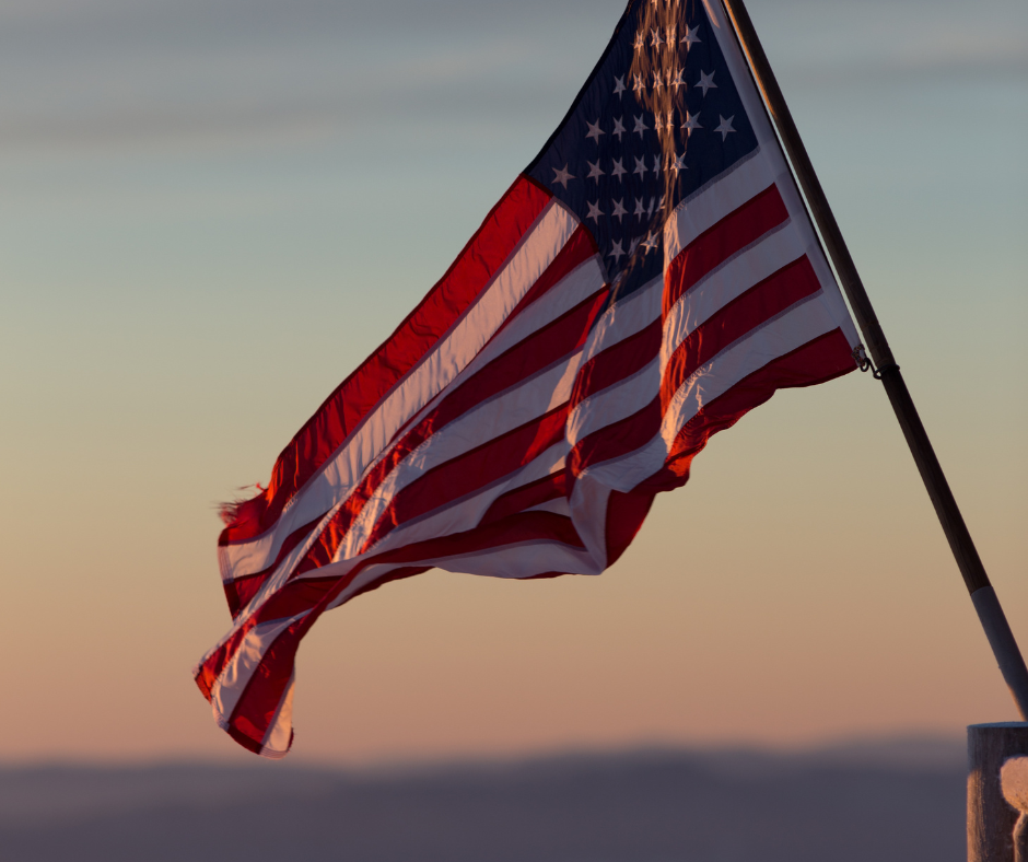 United States Flag Waving with Water in Background